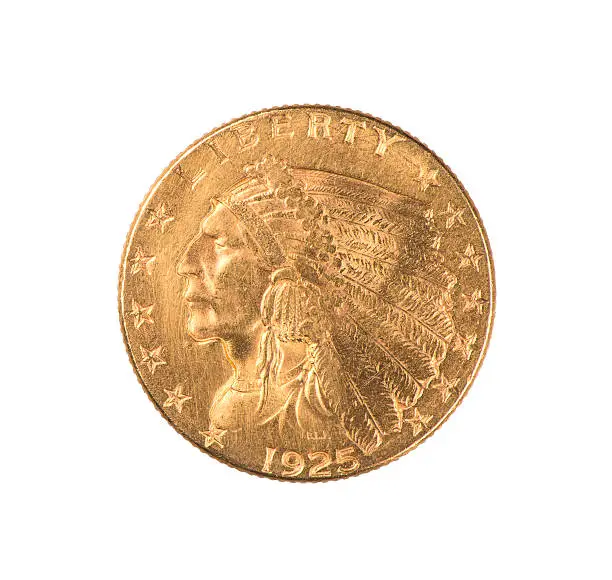 An authentic gold Indian Quarter Eagle coin minted 1925 in the  United States.  Designed by Boston sculptor Bela Lyon Pratt, it has an unusual incused design. The face value is $2.50.  Isolated.