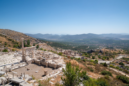 Panoramic view o the Theatre of Dionysus, ancient greek theater on a sunny day with city of Athens in the background