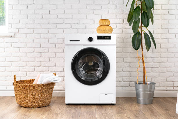 istock Washing machine and basket in a laundry room 1701832857