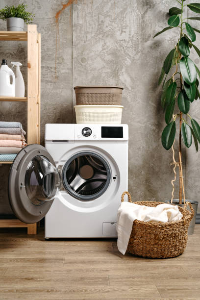 istock Laundry room interior with washing machine near gray grunge wall 1701836887