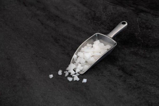 istock Sea salt in spoon on stone texture background 1701840840