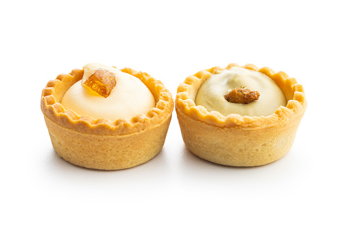 Sweet tarlets. Tasty mini tarts. Mini pie with cream isolated on the white background.