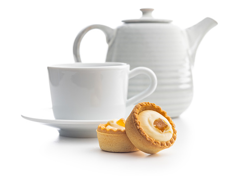 Sweet tarlets. Tasty mini tarts and coffee cup. Mini pie with cream isolated on the white background.