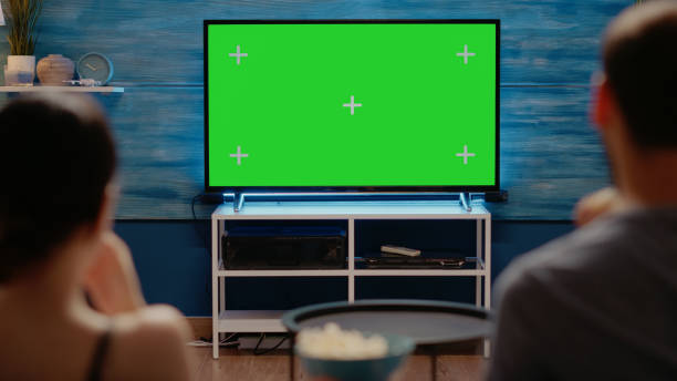 istock Young adults looking at modern technology green screen 1701859852