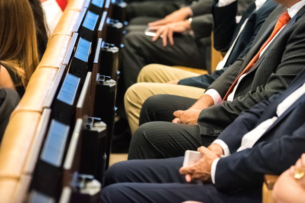 istock People attending congress sitting in seats 1701860417