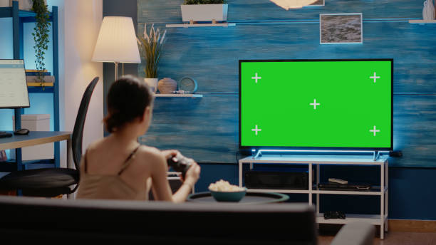 istock Person using joystick and green screen display on tv 1701861445