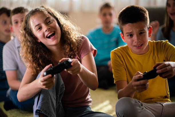 Teenagers playing video game at home