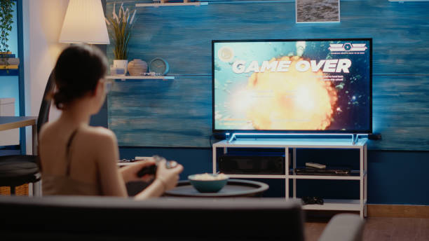 istock Caucasian woman losing while playing video games holding modern controller 1701866707