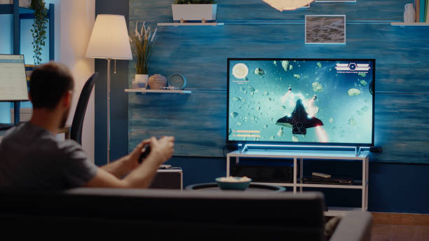 istock Caucasian man playing video games on tv console 1701868384