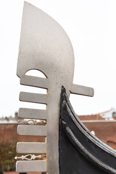 The metal bow fitting of a gondola rises towards the sky.