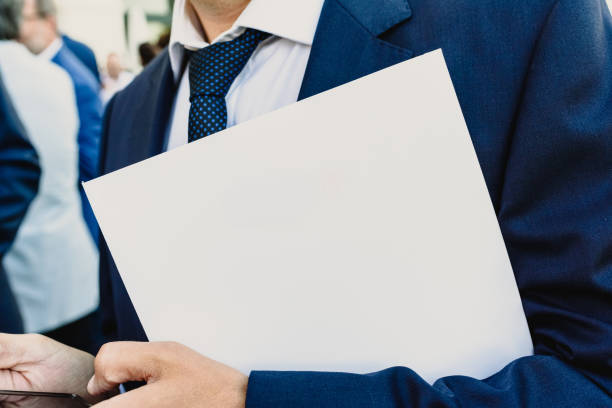 istock Businessman with white folder and mobil phone copy space 1701870049