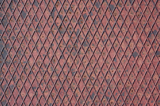 Photograph of rusty metal treads.