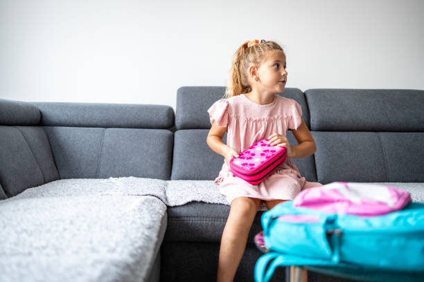 istock Cute girl preparing pencil case before going to school. 1701879545