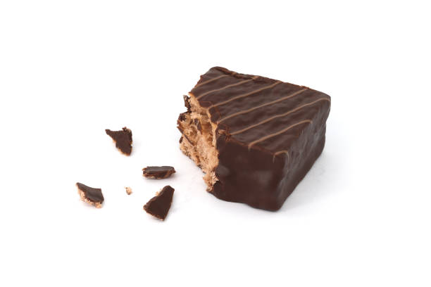 istock Chocolate coated cakes isolated on white background. Chocolate cake cube. Chocolate coated snacks. 1701884237