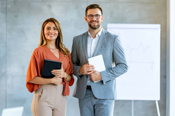 Business partners looking at camera and smiling.