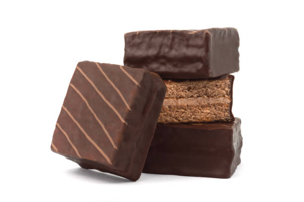 istock Chocolate coated cakes isolated on white background. Chocolate cake cube. Chocolate coated snacks. 1701884799