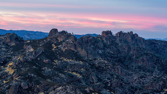 Twilight afterglow over High Peaks via North Chalone Peak. Pinnacles National Park, California, USA.