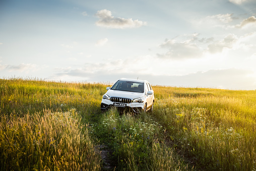 Kyiv region, Ukraine - July 13 2018: Front view of compact crossover in a green meadow - weekend away from the city, exploring the countryside.