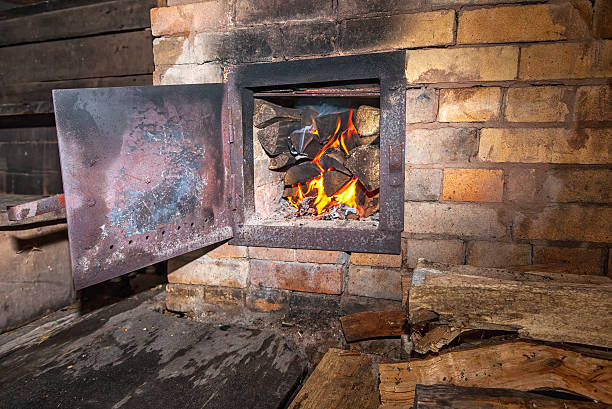 istock Old stove with open door and burning the wood 170189963