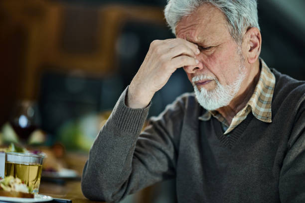istock Senior man having a headache at home. 1701904936