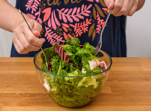 Eat lettuce, salad bowl with colorful fresh salad mix, closeup