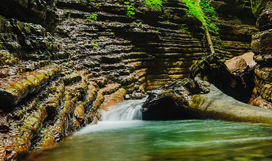 flowing clear cold water in a canyon with layers of the rocks in austria