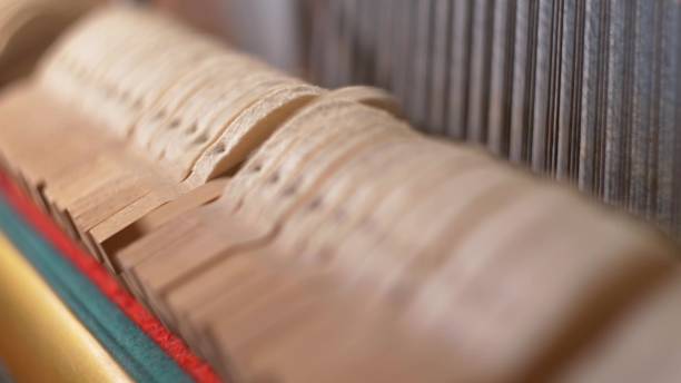istock Upright Piano Mechanism Hammers Striking Strings When Song is Played by Musician 1701912130