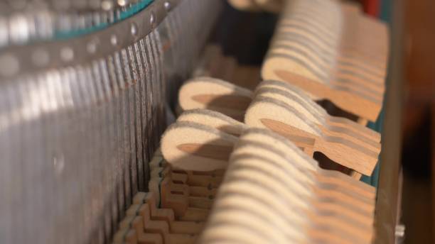 istock Upright Piano Mechanism Hammers Striking Strings When Song is Played by Musician 1701912150