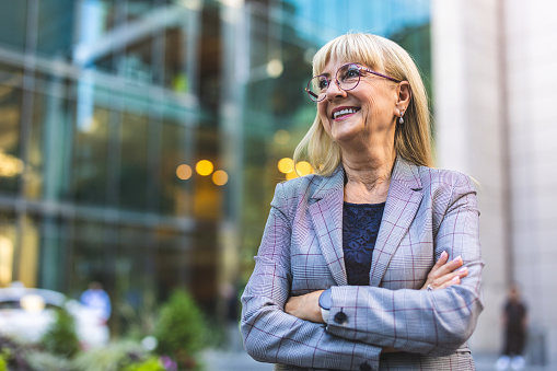 Portrait of smiling senior businesswoman in the city