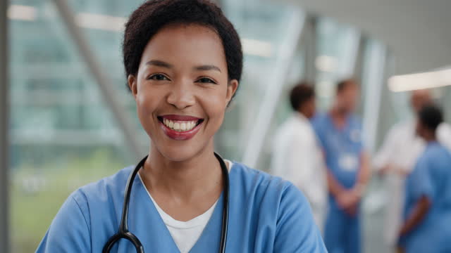 Face, happy nurse and black woman in hospital for healthcare and career in wellness. African medical professional, portrait and smile of female surgeon, confident worker and expert employee in clinic