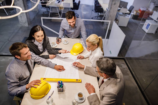 istock Above view of team of architects analyzing blueprints in the office. 1701921659
