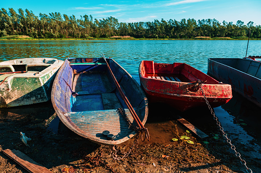 Old worn fishing boats on Danube river, selective focus