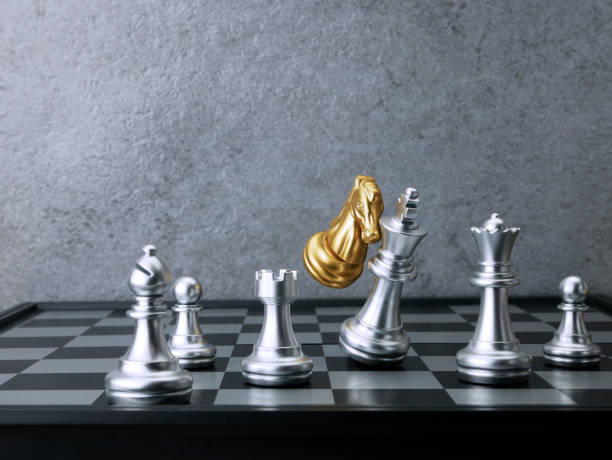 istock Golden knight chess attack silver king chess. Leadership Concepts. 1701932482