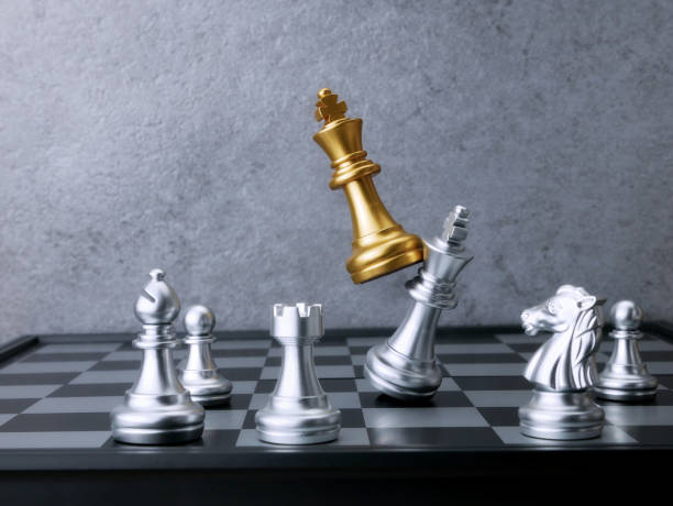 istock Golden king chess attack silver king chess. Leadership Concepts. 1701933104