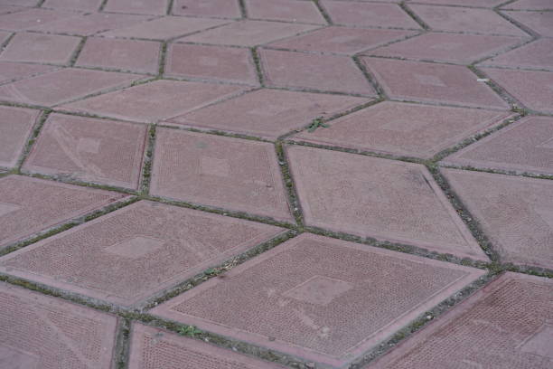 istock Close shot of grayish pink diamond shaped concrete pavement with geometric pattern 1701955239