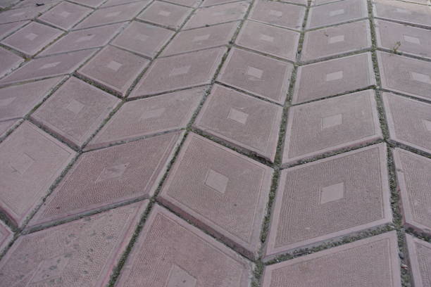 Close view of grayish pink diamond shaped concrete pavement with geometric pattern