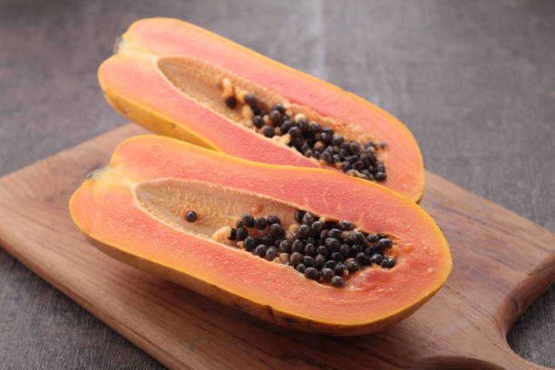 istock ripe and sweet papaya fruit on gray background 1701962641