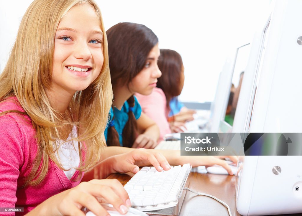 Happy Kids Sitting Together And Using Computer Stock Photo - Download ...