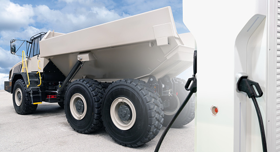 Electric charging station on a background of electric mining truck. Concept