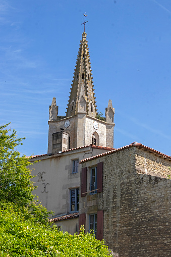 The steeple of Saint-Cyr d'Arçais church, built in 1861, seen from downtown.