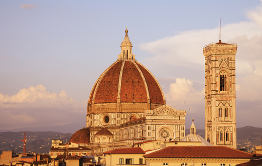 Golden sunrise over Cathedral of Santa Maria del Fiore (Duomo) and Campanile - Florence, Italy.