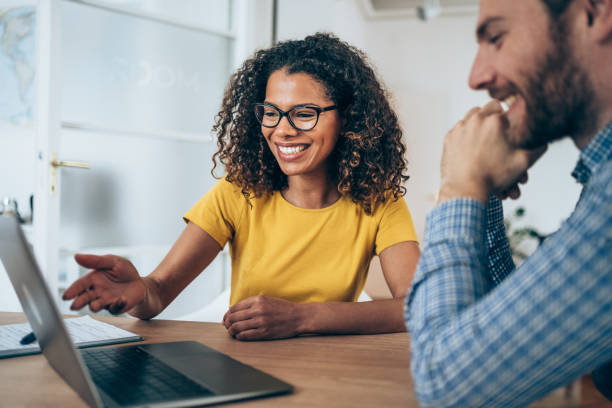istock Confident business partners working on laptop in office. 1701982070