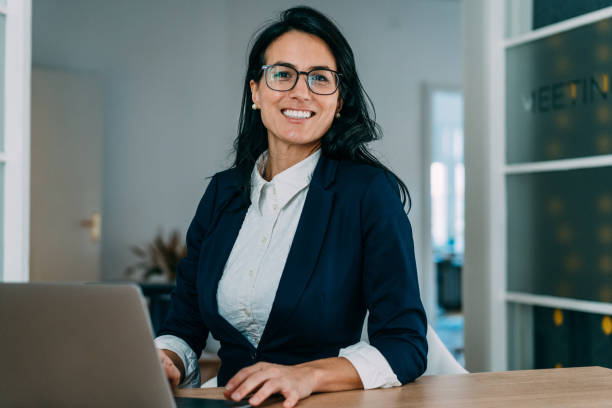 istock Successful businesswoman in modern office working on laptop. 1701982095