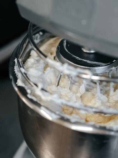 istock Cake cream being whipped in a large mixer close-up 1701992310