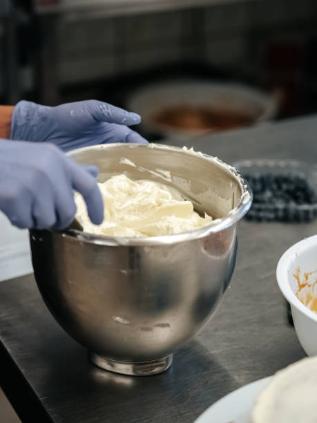istock Pastry chef holding a large bowl of whipped cream 1701992782