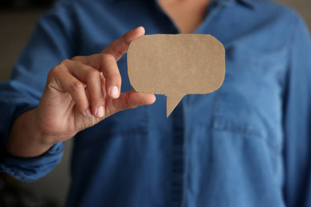 istock Woman holding blank paper speech bubble 1701993947