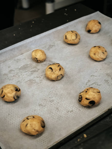 istock Raw cookies with chocolate on a baking sheet close-up 1701996466