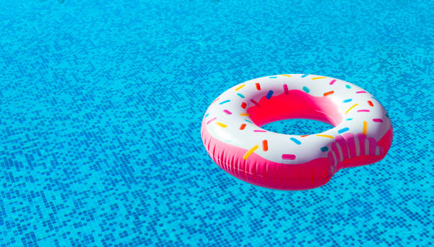 istock Inflatable colorful rubber donut float ring in swimming pool on sunny day 1702004847