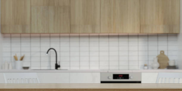istock Modern empty wooden table top or kitchen island for montage product display on blurry Scandinavian kitchen room interior background. 3d rendering illustration 1702009909
