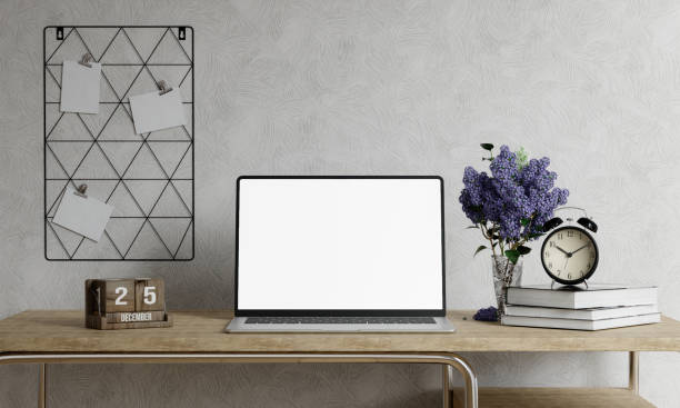 istock Minimalist workspace with a laptop mockup on a table in a minimal office. 3d render illustration 1702015527